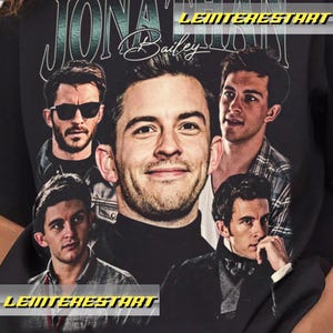 May include: Black t-shirt featuring a collage of images of Jonathan Bailey, with the name "Jonathan Bailey" in a vintage-style font. The design includes multiple portraits of the actor in various poses.