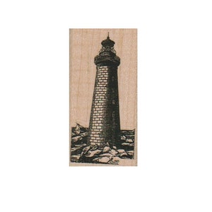 May include: A black and white illustration of a lighthouse on a rocky shore.