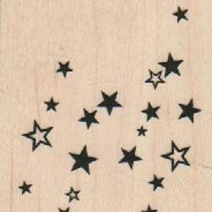 May include: A wooden block with a design of multiple black stars of varying sizes scattered across the surface.