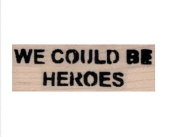 Puede incluir: Sellos de madera con el texto "WE COULD BE HEROES" en tinta negra.