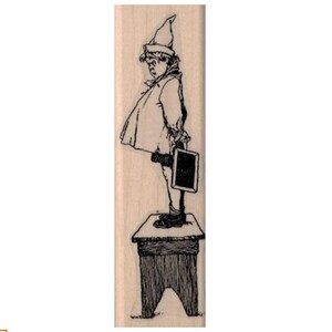 May include: A black and white illustration of a child wearing a hat and holding a small chalkboard. The child is standing on a wooden stool.