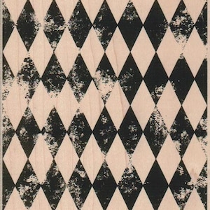 May include: A black and white diamond pattern rubber stamp. The stamp has a distressed look, with some of the diamonds appearing faded or worn.