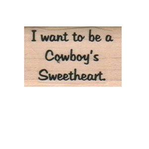 Può includere: Un timbro di legno con il testo "I want to be a Cowboy's Sweetheart" in inchiostro nero.