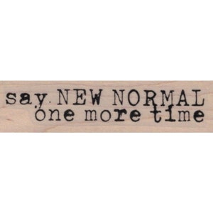 May include: A wooden stamp with the text "say NEW NORMAL one more time" in black ink.