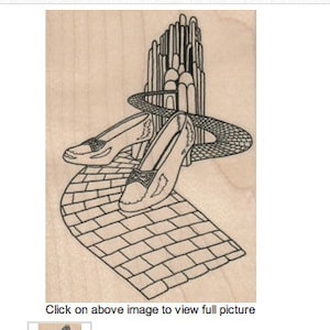 Może przedstawiać: Czarno-biała ilustracja pary rubinowych pantofelków na żółtej drodze z cegły prowadzącej do Szmaragdowego Miasta.