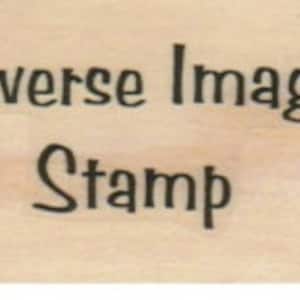 May include: A wooden stamp with the text "Reverse Image Stamp" in a cursive font.