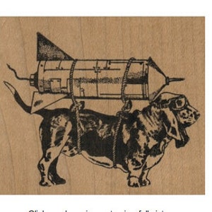 May include: A black and white illustration of a basset hound wearing goggles and carrying a rocket strapped to its back.