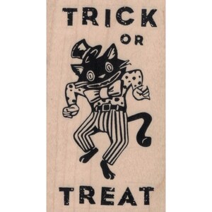 May include: A black and white rubber stamp with a cartoon cat wearing a top hat and bow tie. The stamp reads "Trick or Treat".