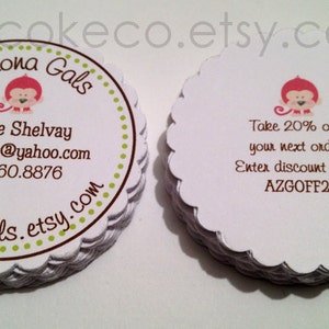 May include: White, scalloped-edge business cards stacked. One card features a monkey graphic and business details: Arizona Gals, LyNae Shelvay, email, and phone number. Another card offers a 20% discount with code AZGOFF20.