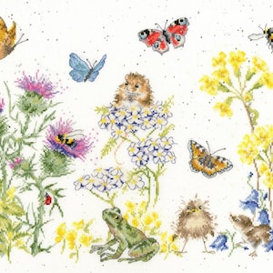 May include: A cross-stitch pattern featuring a brown hamster sitting on white flowers, a green frog, two small brown birds, and various insects including butterflies, a bumblebee, and ladybugs amidst purple thistles and yellow flowers.