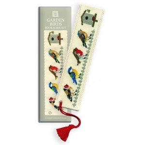 May include: A cross-stitch bookmark kit featuring a design of colourful garden birds perched on a fence with a birdhouse. The kit includes a white Aida cloth, embroidery floss, and a needle. The packaging features the text "Garden Birds Bookmark Kit".