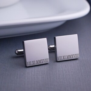 square, stainless steel cufflinks engraved with a roman numeral date.