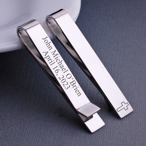 Engraved tie bar with a cross on the front. The back can be personalized.