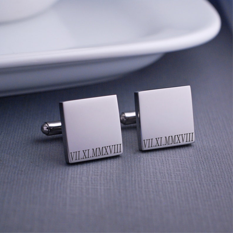 square, stainless steel cufflinks engraved with a roman numeral date.
