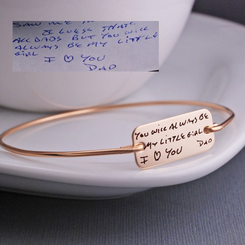 gold bangle bracelet with handwritten message engraved showing a photo of the original handwriting in the upper left corner