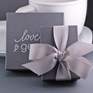 Grey gift box and grey bow.