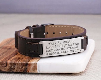 May include: A brown leather bracelet with a silver metal plate engraved with the text: "This is what I look like with the maximum of around 70 characters on it."