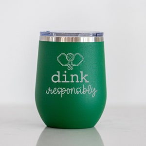 May include: Green stainless steel tumbler with a white design of two pickleball paddles and the text "dink responsibly".