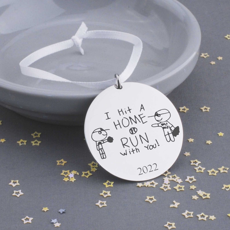 This 1 1/4 inch stainless steel disc is custom engraved with YOUR child's actual artwork.