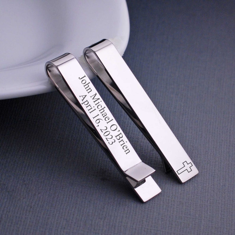 Engraved tie bar with a cross on the front. The back can be personalized.