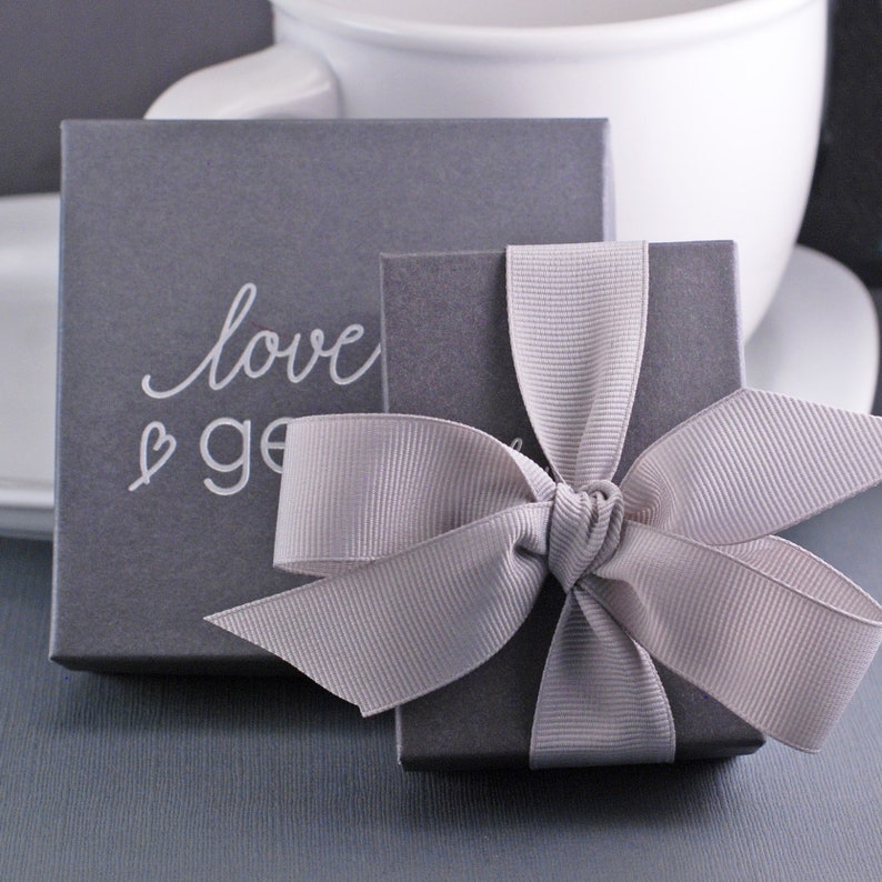 Grey gift box with a grey bow