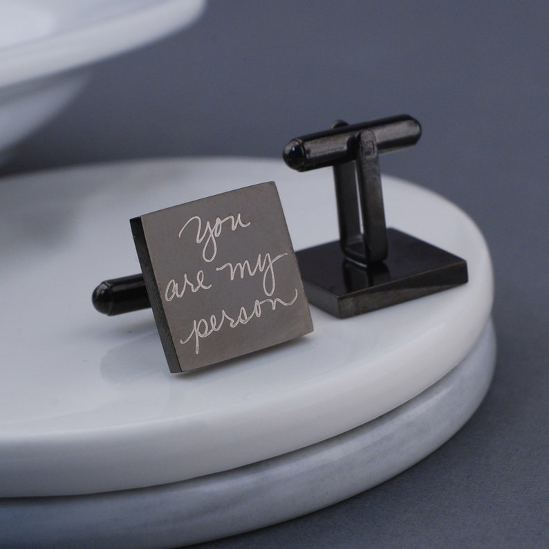 showing the front and back side of square gunmetal cufflinks.  Engraved with a handwritten message.