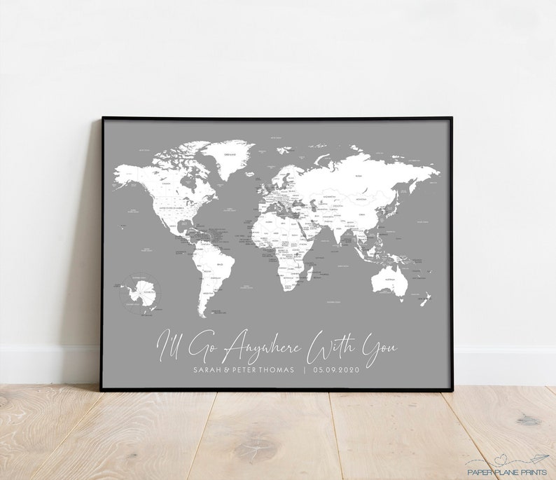 May include: A grey world map print with white countries and text that reads "I'll Go Anywhere With You" with the names "Sarah & Peter Thomas" and the date "05.09.2020" below the map.