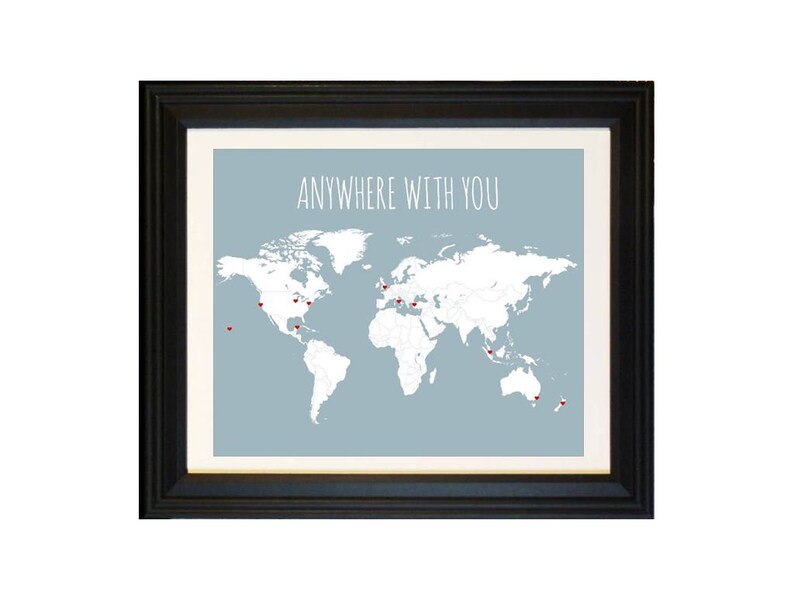 May include: A framed print with a world map and the text "Anywhere with you" in white lettering on a light blue background. Red heart-shaped pins are placed on the map.
