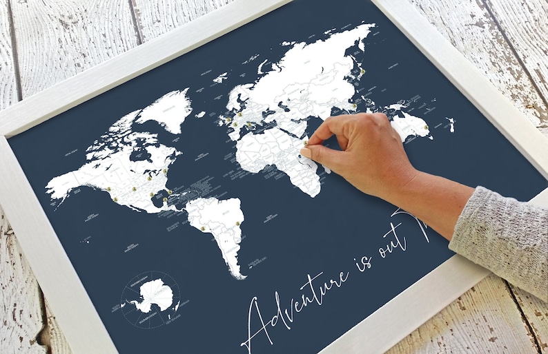 Beautiful decorative couples world push pin map for marking travels and places visited. With script cursive Adventure is out There travel quote title. Shown in navy blue and customizable to other colors and personalized names and date.