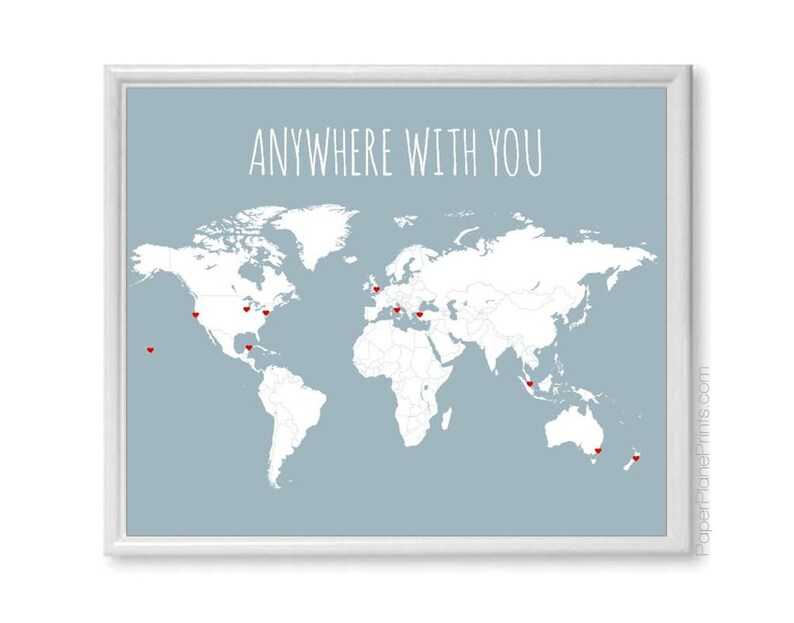May include: A light blue world map print with the text "Anywhere with you" at the top. Red heart pins mark locations on the map.