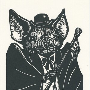 May include: A black and white illustration of a bat wearing a top hat and a bow tie, holding a cane. The bat has a friendly expression and is dressed in a suit.