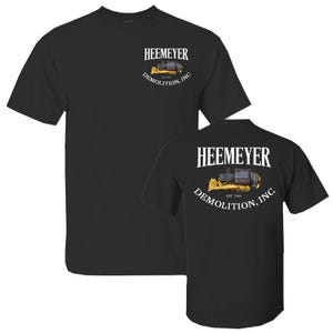 May include: Black t-shirt with a white graphic of a yellow bulldozer with the text "Heemeyer Demolition, Inc. Est. 2006" on the back.