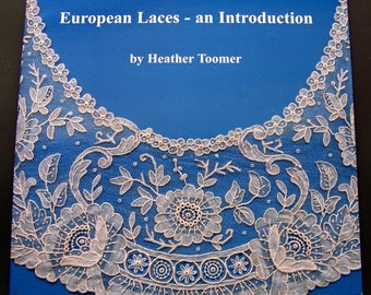 May include: A book cover with a blue background and white lace trim. The title is "European Laces - an Introduction" by Heather Toomer.