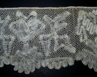 May include: A delicate white lace trim with a floral pattern. The lace is made of fine threads and has a delicate, intricate design.