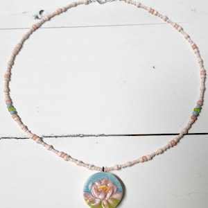handmade ceramic pendant with handpainted lotus flower all in pink