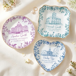 May include: Three decorative ceramic dishes with floral and university building designs. One round dish features a purple Boston University design, a square dish has a blue Duke University design, and a heart-shaped dish has a blue Harvard University design.