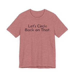 May include: A heather red t-shirt with the text "Let's Circle Back on That." printed in black.