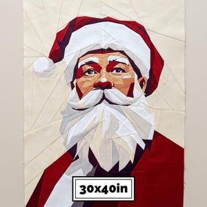 May include: A geometric fabric quilt block featuring a portrait of Santa Claus in red, white, and cream tones. The design is composed of angular fabric pieces forming a face with a beard and hat. A label at the bottom displays the text 30x40in.