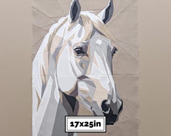 May include: A fabric quilt block featuring a geometric, pieced design of a horse head in shades of white, gray, and beige. The horse is rendered in angular, faceted shapes. A rectangular label at the bottom displays the text 17x25in.