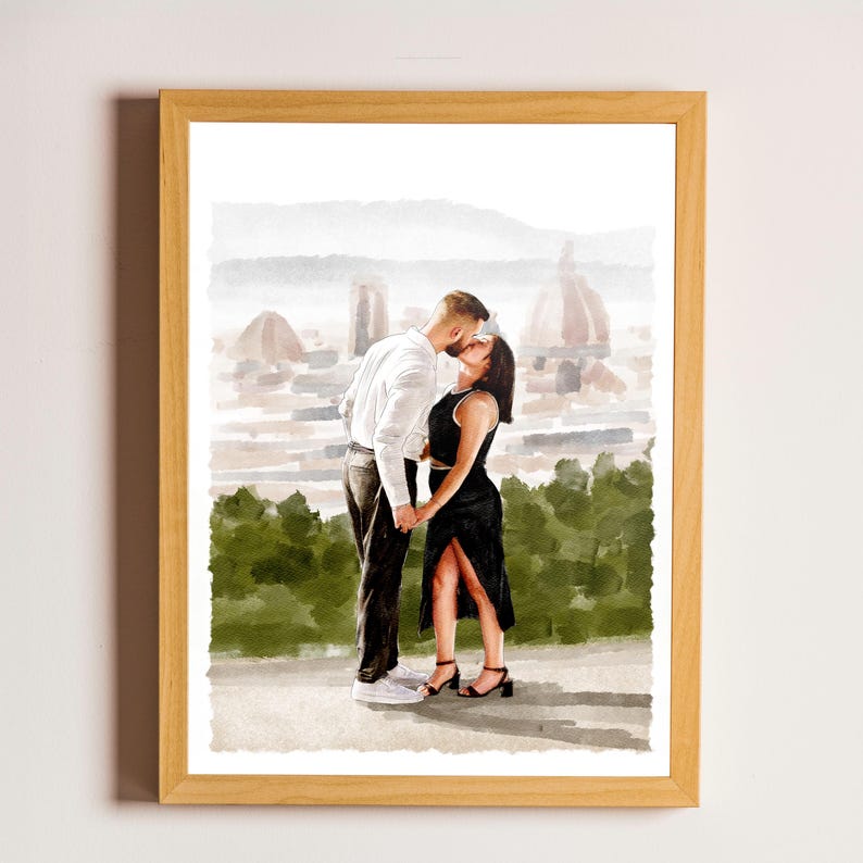 May include: A framed watercolour illustration depicting two people kissing outdoors. One person wears a white long-sleeved shirt and dark trousers, while the other wears a black sleeveless dress with a side slit. A blurred cityscape background.