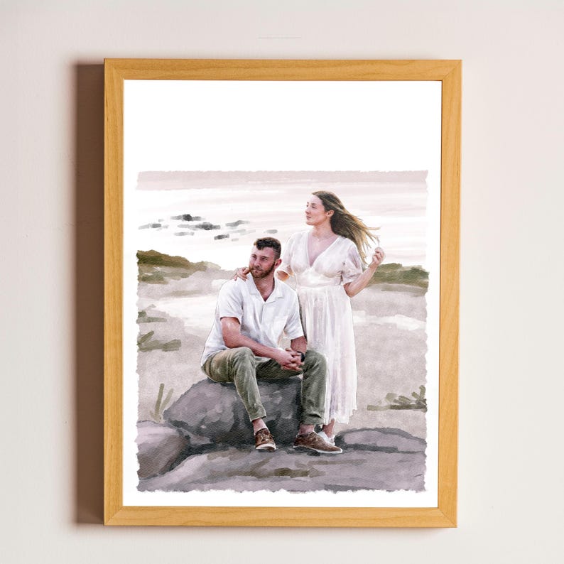 May include: A framed watercolour-style print depicting two individuals outdoors. One person sits on a large rock wearing a white short-sleeved shirt and olive green trousers, while the other stands beside them in a long, flowing white dress.