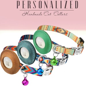 May include: Three personalized cat collars with colorful patterned fabric and leather name tags. The collars feature a breakaway buckle and a bell. The name tags are personalized with the names "Raven", "Bella", and "Jasper".