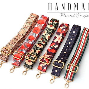 May include: Six colorful printed fabric straps with gold metal hardware. The straps are handmade and feature various floral and geometric patterns.  "Handmade Printed Straps" is written in the image.