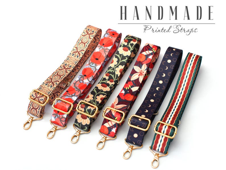May include: Six colorful printed fabric straps with gold metal hardware. The straps are handmade and feature various floral and geometric patterns.  "Handmade Printed Straps" is written in the image.