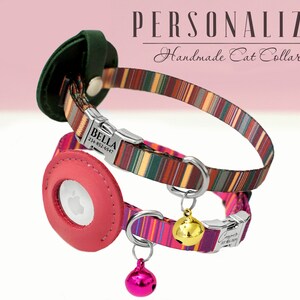 May include: Two personalized cat collars with colorful striped patterns. The top collar is brown, green, and orange with a silver buckle and a name tag that reads "BELLA 234-852-6947". The bottom collar is pink, purple, and green with a silver buckle and a gold bell. Both collars have a leather patch with a clear window for a microchip.
