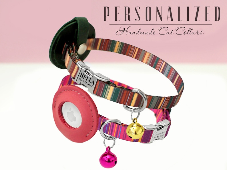 May include: Two personalized cat collars with colorful striped patterns. The top collar is brown, green, and orange with a silver buckle and a name tag that reads "BELLA 234-852-6947". The bottom collar is pink, purple, and green with a silver buckle and a gold bell. Both collars have a leather patch with a clear window for a microchip.