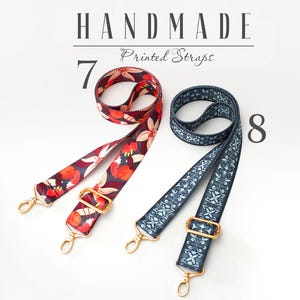 May include: Two handmade printed straps. One strap is red with floral print and the other is blue with a geometric pattern. Both straps have gold metal hardware.