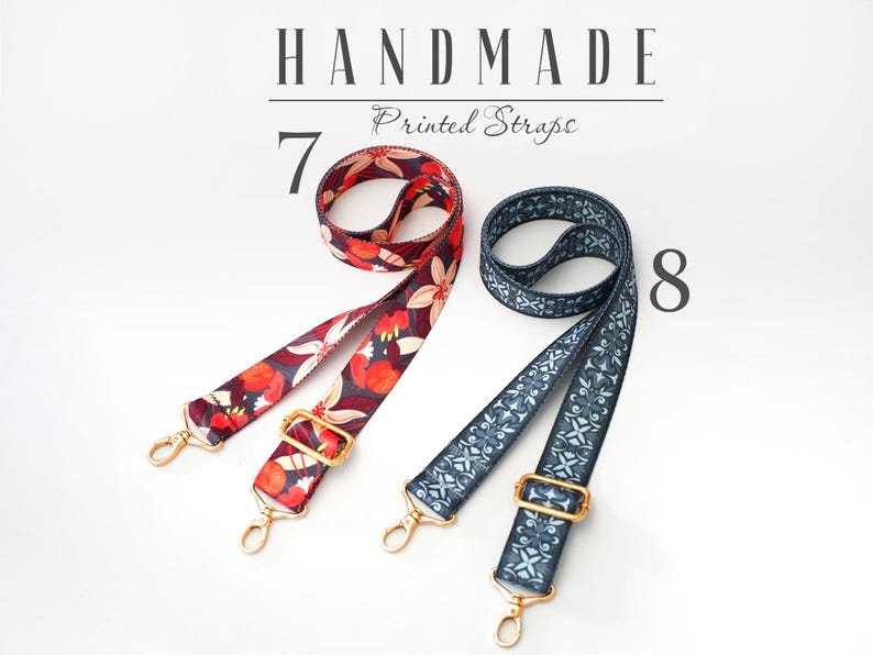 May include: Two handmade printed straps. One strap is red with floral print and the other is blue with a geometric pattern. Both straps have gold metal hardware.
