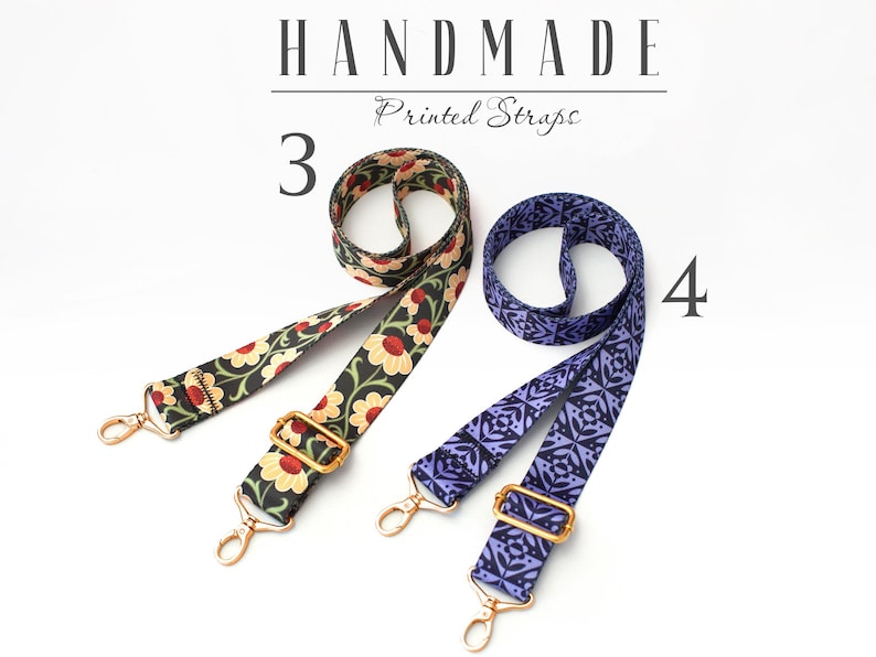 May include: Two handmade printed straps. One strap is black with red and yellow floral print. The other strap is purple with a geometric pattern. Both straps have gold metal hardware.