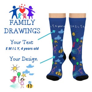 May include: A pair of blue socks featuring a colourful drawing of a child holding balloons, a bee, and clouds. The socks are inscribed with the text "EMILY, 4 years old". These socks are part of a family drawing themed collection.